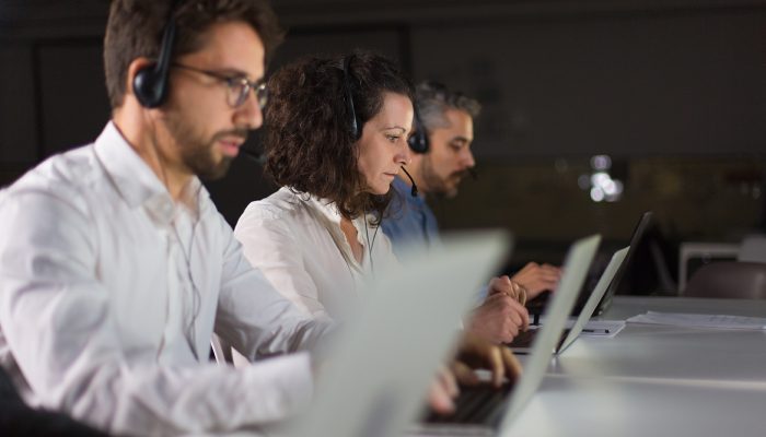 Client support team at workplace. Thoughtful call center operators during working process. Call center concept